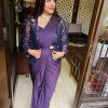Indian women smiling wearing a ready to wear purple saree