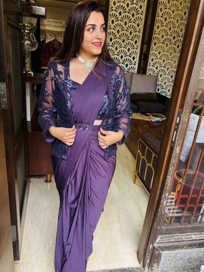 Indian women smiling wearing a ready to wear purple saree