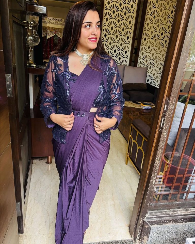 Indian women smiling wearing a ready to wear purple saree
