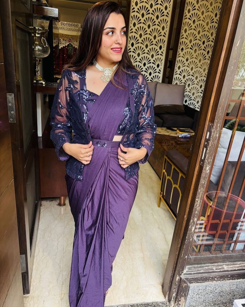 Indian women smiling wearing a ready to wear purple saree