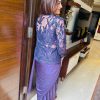 Women showing back of a ready to wear saree