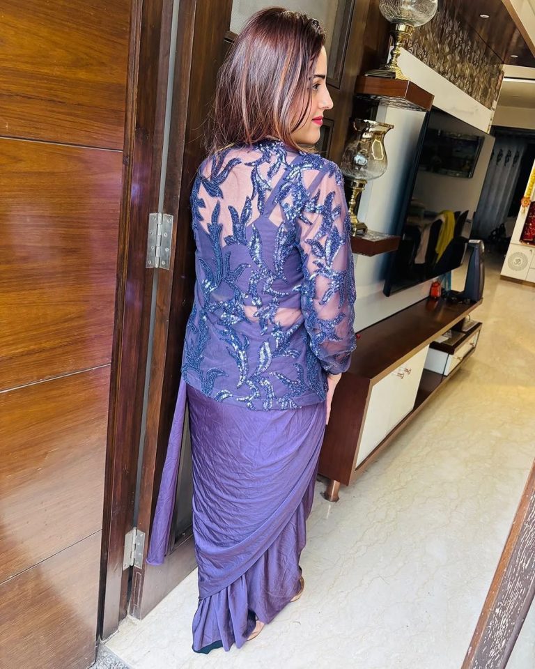 Women showing back of a ready to wear saree