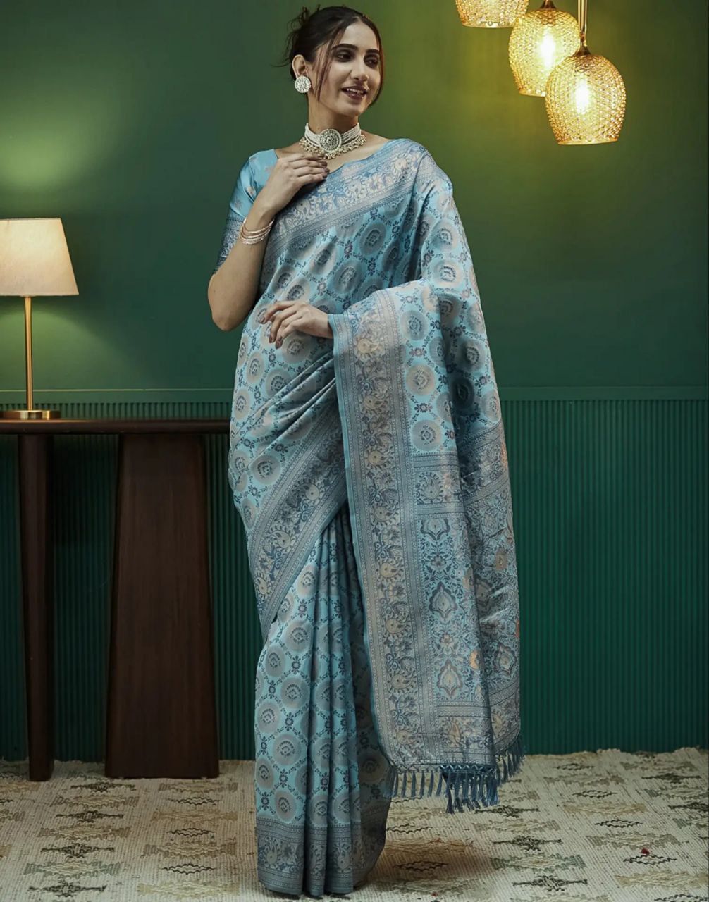 Indian lady wearing a green blue saree from Rivaaya.in